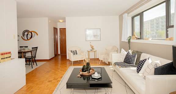 A living room with a white couch and a coffee table.