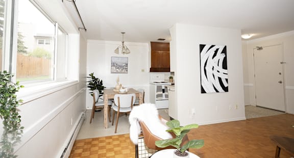 A modern living room with a black coffee table and a white sofa.