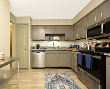 a kitchen with stainless steel appliances and granite counter tops