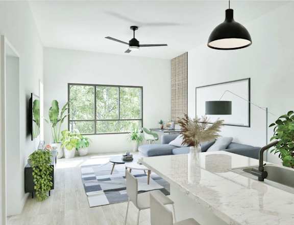 A modern kitchen with a marble countertop and a ceiling fan.