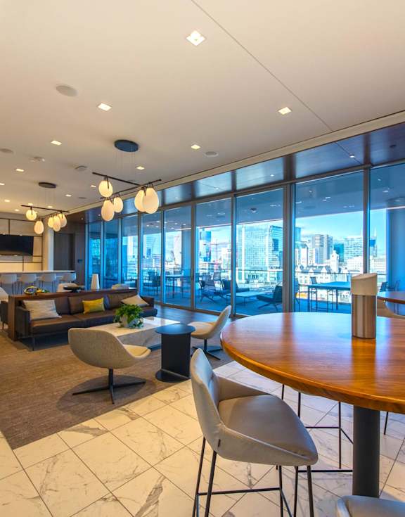 A modern dining area with a view of the city.