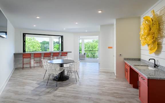 a kitchen and dining room with a table and chairs