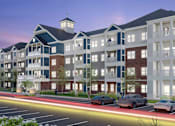 Thumbnail 1 of 4 - A modern apartment complex with cars parked in front.
