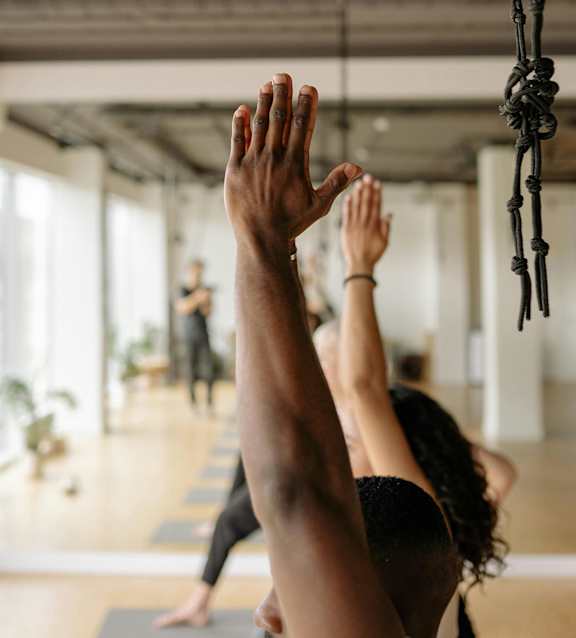 A group of people practicing yoga in a studio.