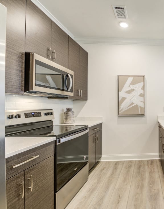 a kitchen with an island and a stove and a microwave at Residences at 393 North Apartments, Santa Rosa Beach, Florida