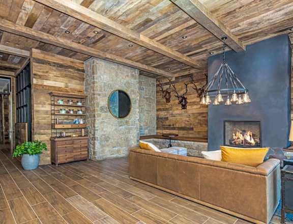 A cozy living room with a fireplace and a couch  at Bridges at Flatiron, Broomfield, 80021
