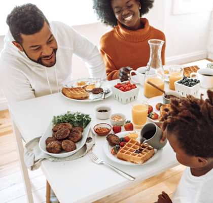 happy couple enjoying breakfast at home