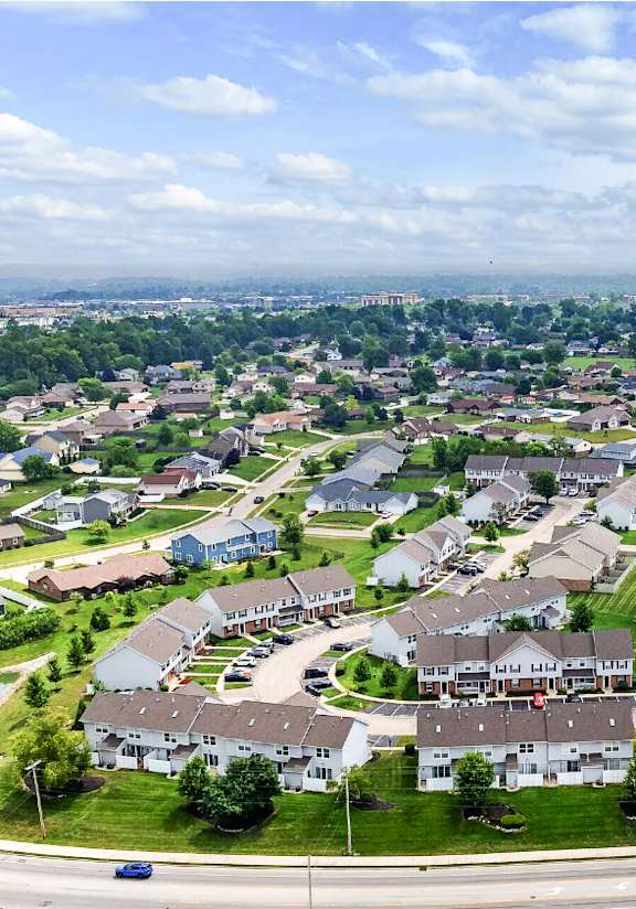 A suburban neighborhood with a large house in the center.