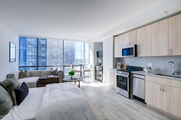 A modern kitchen with wooden cabinets and stainless steel appliances.