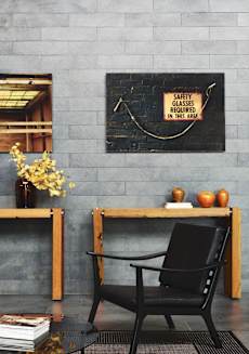 a office with a chair and a desk and a sign on the wall