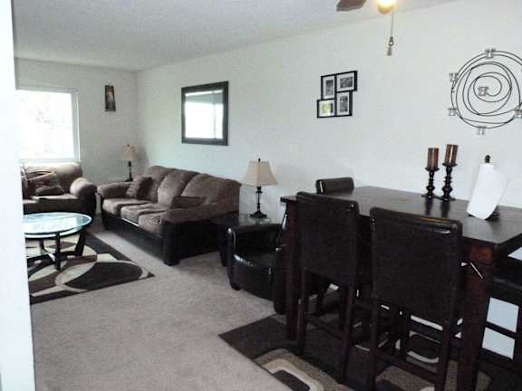 an empty living room and kitchen with a wood floor