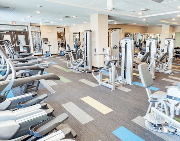 a spacious fitness center with cardio equipment and weights in a gym at Gabella at Parkside, Minnesota, 55124