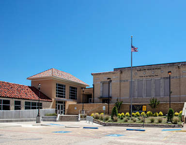 A building with a flag on top and the words "Ball High School" on the side.