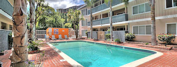 A Madison Place apartment building with a parking lot in front.