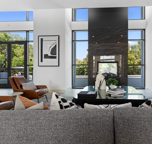 A modern living room with a grey sofa and a coffee table.