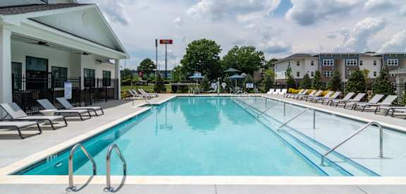 Resort-inspired community swimming pool at Blue Sky Landing apartments in College Park, GA near Hartsfield-Jackson Atlanta International Airport and Old National Parkway.