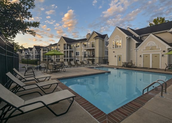 our apartments have a swimming pool with chairs and umbrellas