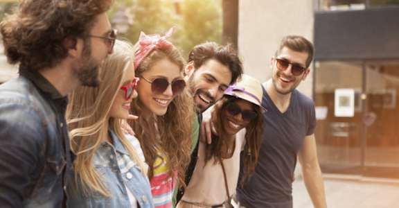A group of friends are walking together on a sunny day.