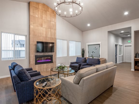 a living room with couches and a table and a fireplace