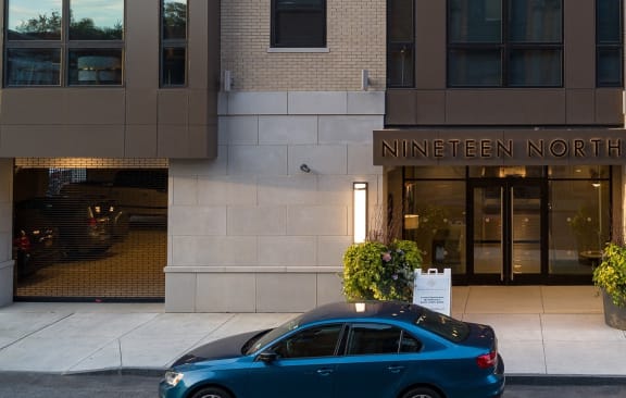 a woman walks past the entrance to the ninfenner mortimer building at Nineteen North, Buffalo