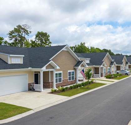 a row of houses on the side of a street at River Oaks, Little River