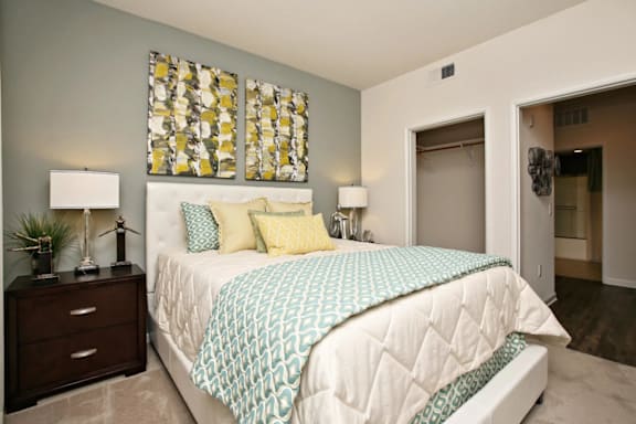 A bedroom with a bed, nightstand, and lamp at The Kitt at Warner Center in California, 91303