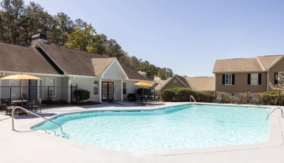 a swimming pool with apartments in the background