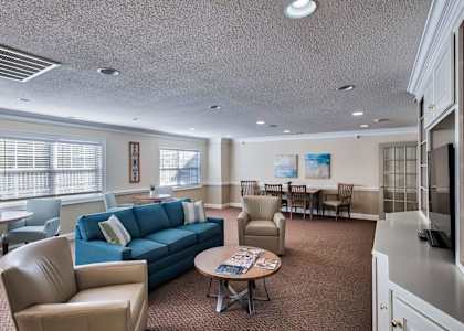 a living room with couches chairs and a television