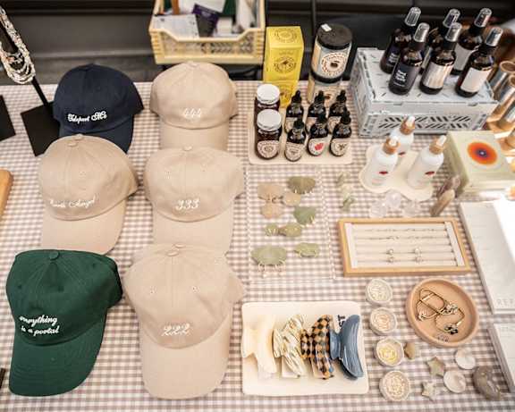 a variety of hats and other items are displayed on a table