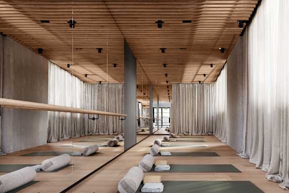 A yoga studio with mats and pillows on the floor.