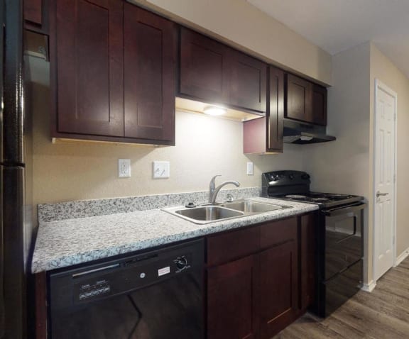 a kitchen with a sink and a refrigerator