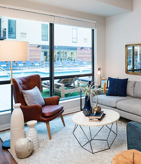 Inviting Living Room With Tall Ceilings & Lots Of Natural Light