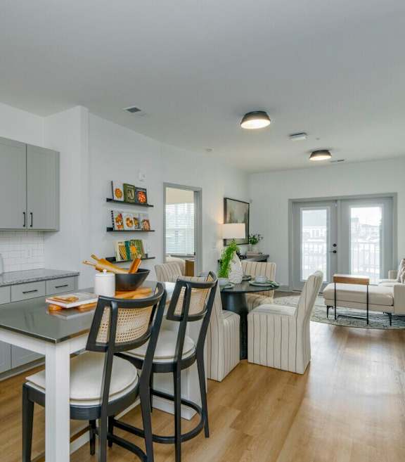 A modern kitchen with a dining table and chairs.