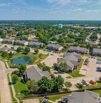 an aerial view of a neighborhood with houses and a pond at Chapel Ridge of Stillwater I & II, Stillwater, 74075
