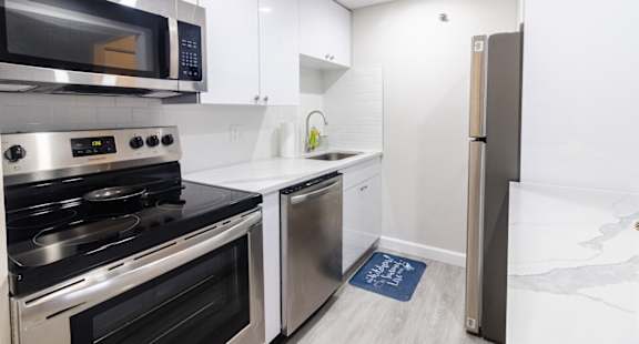 A kitchen with a stainless steel oven and microwave.