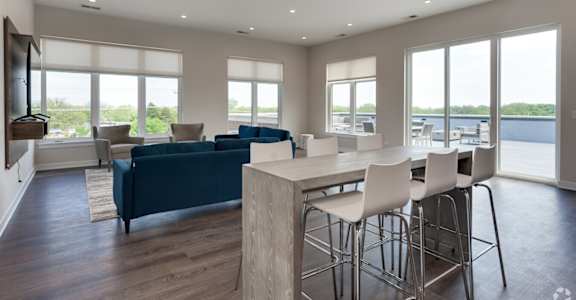 a large living room with a dining room table and chairs