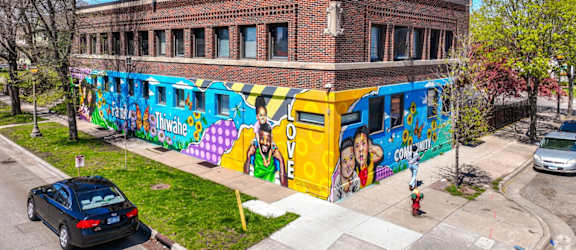 A mural on a building with the word "love" written on it.