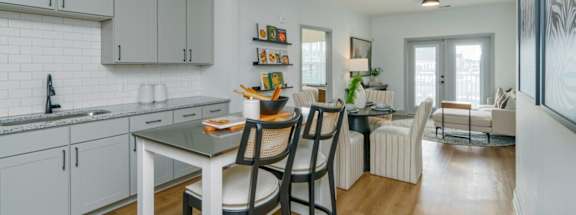 A modern kitchen with a dining table and chairs.