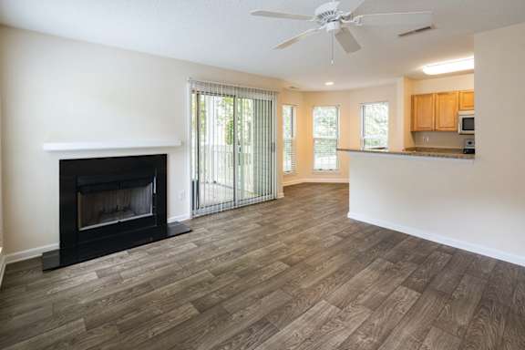 A living room with a fireplace and sliding glass doors.