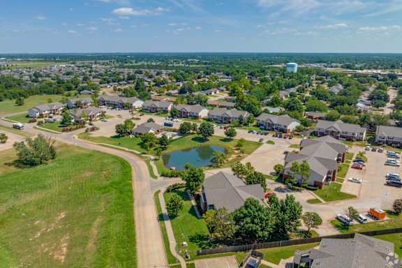 A suburban neighborhood with houses and a pond  at Chapel Ridge of Stillwater, Stillwater, OK, 74075