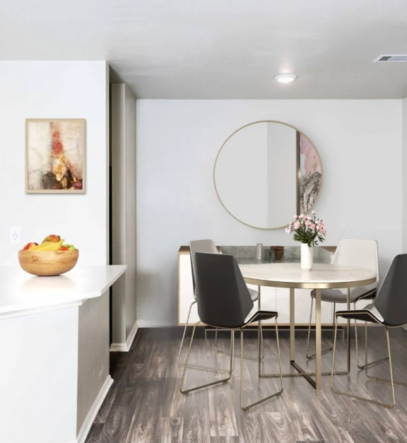 a dining room with a table and chairs and a kitchen