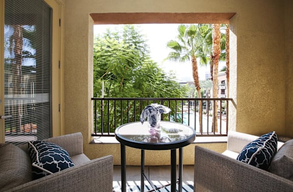 A balcony with a table and two chairs at The Kitt at Warner Center in Woodland Hills, CA, 91303