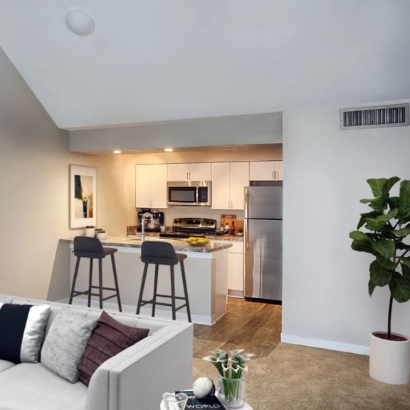 a living room and kitchen with a couch and a bar at Skyview Apartments, Colorado
