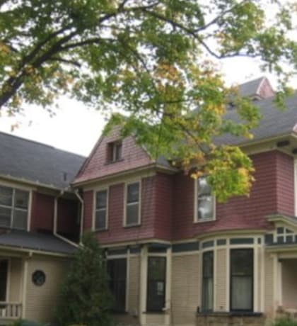 a large house with a large tree in front of it