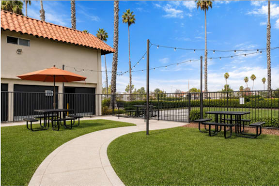 A patio area with picnic tables and a pathway.