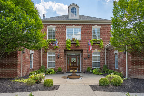 a view of the front of a brick building with a fountain at Bishops Gate, Cincinnati, OH, 45249