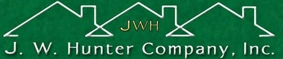 a green sign with the words j w hunter company