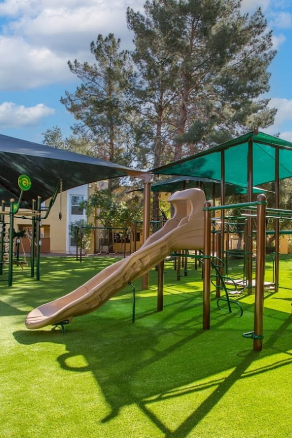 a playground with a slide and climbers