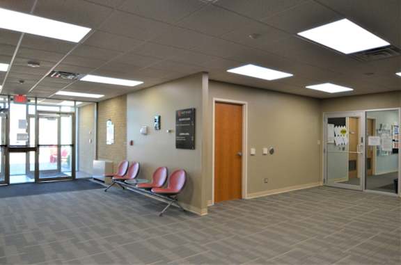 A waiting area with chairs and a door.