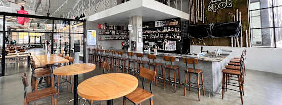 A modern restaurant with wooden tables and chairs at Aspire Apollo, Camp Springs, MD